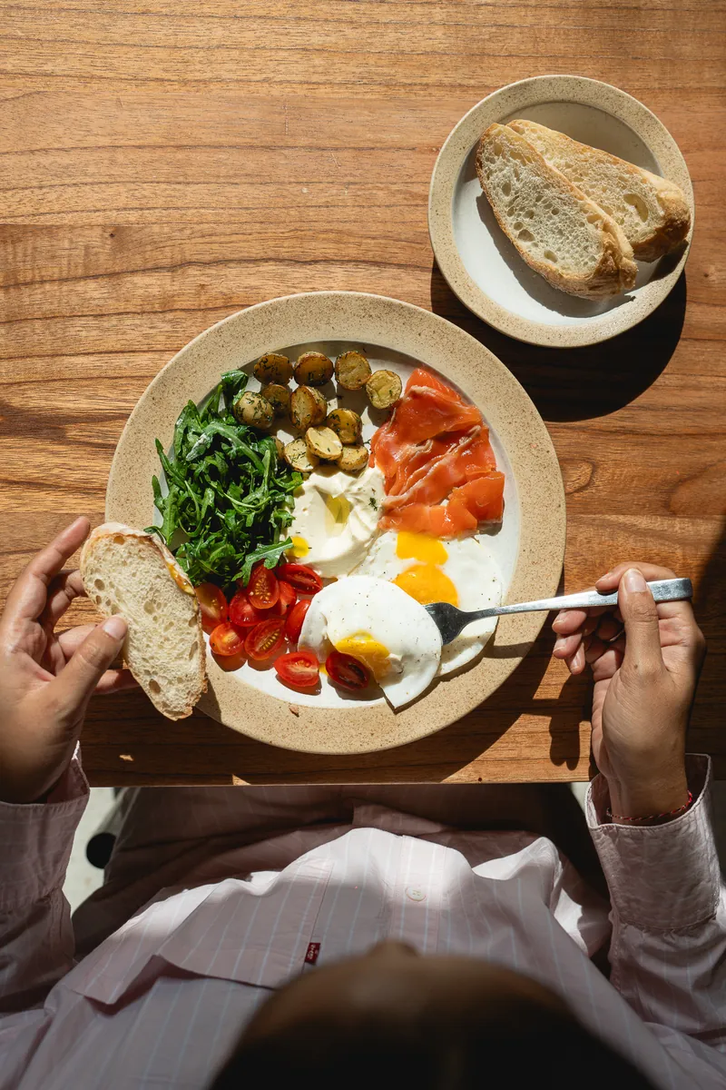 Breakfast of eggs, salad and bread, seen from above