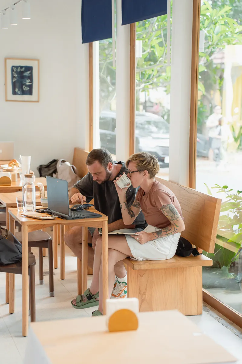 Guests working at a table by the window