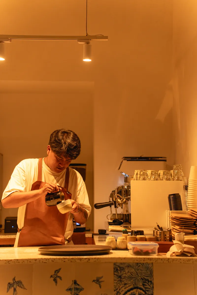 Barista preparing coffee at the bar