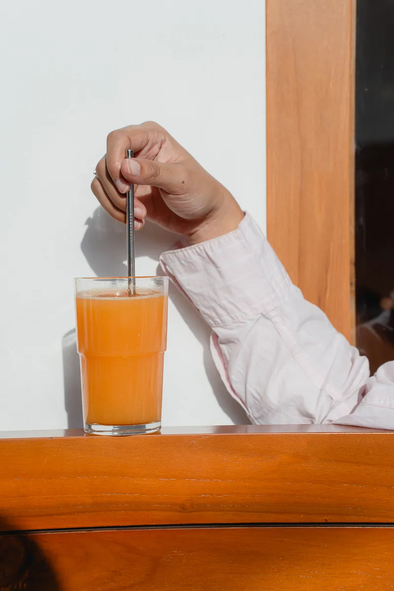 Fresh orange juice being stirred