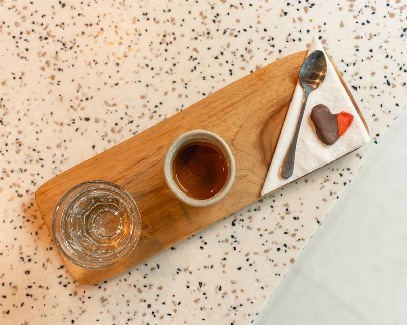 Espresso and dessert on a wooden board