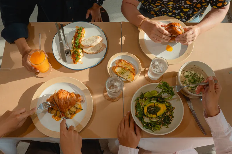 Friends sharing brunch dishes, seen from above